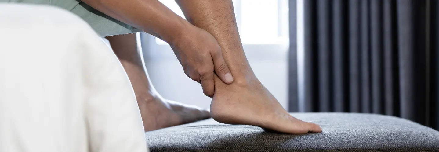 Bioptron light therapy positioned near the back of the ankle during an Achilles recovery routine