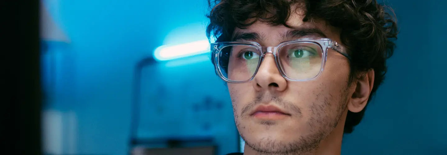 New Zealand professional comparing organised indoor, outdoor and clip-on blue light glasses at a workplace doorway
