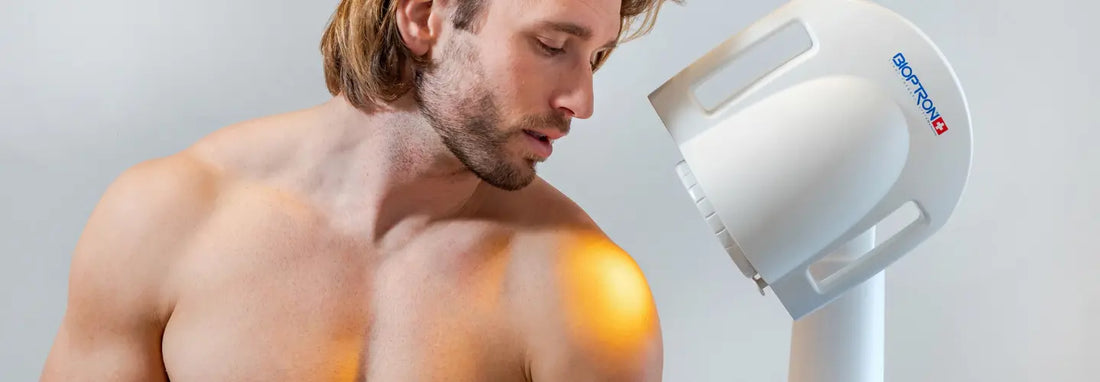 Adult using red light therapy for muscle strain recovery at home with the sore leg supported and relaxed.